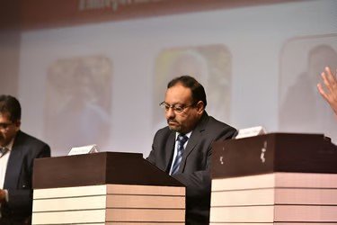 Prof. Sijariya seated on a dais during a session